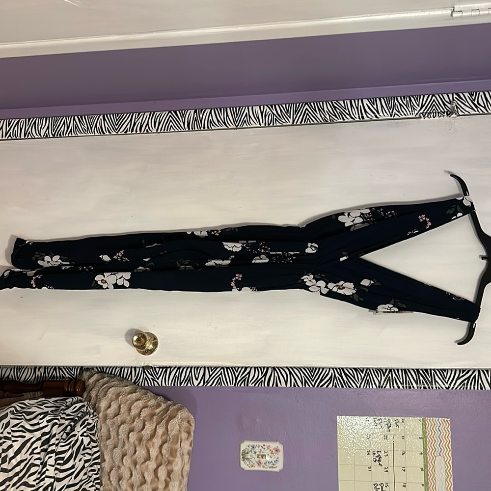 Women’s medium jumpsuit. Navy with floral print. New with tags still attached.